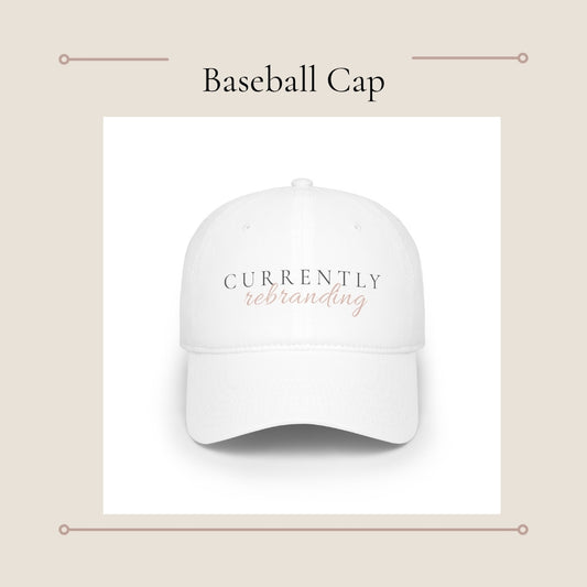 Currently Rebranding Cap | White baseball hat with script text